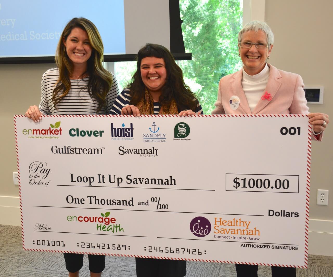 Enmarket and Healthy Savannah presents check to Loop It Up Savannah