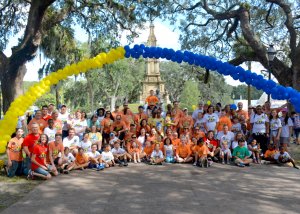 Families of Lowcountry Down Syndrome Society under the arch during the Buddy Walk in Savannah