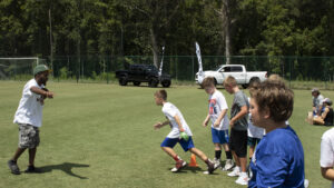 Peacock Automotive Supports Kids and Pros Football Camp