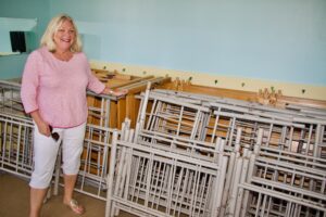 Diane Wesley, volunteer with Fresh Air Home, stands in front of the new bunk beds.